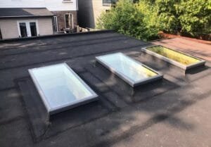 flat glass curb mounted skylight on flat roof