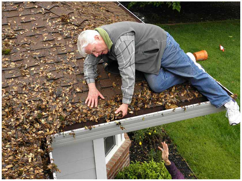 Gutter Cleaning older man on edge of roof